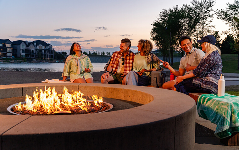 Group of friends gathering by a fire pit