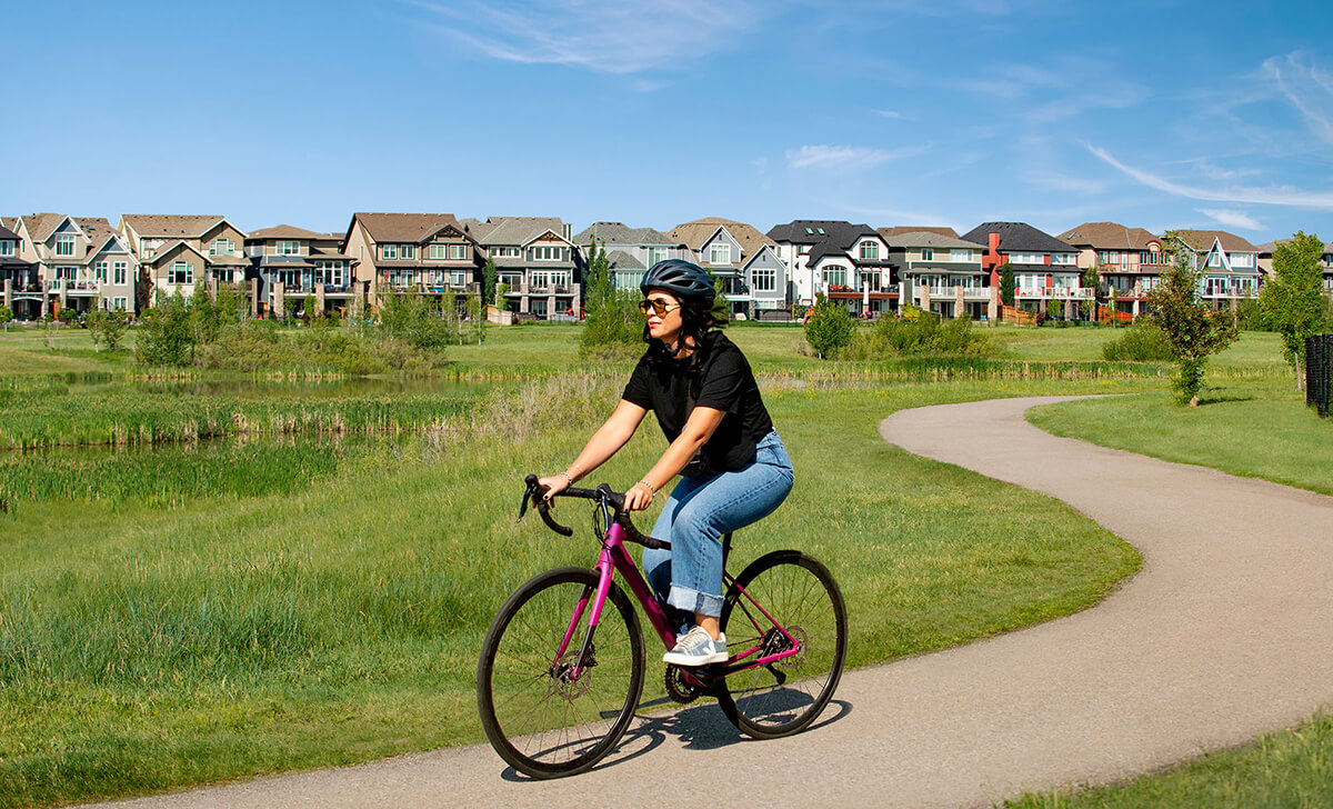 Woman riding bike on pathway